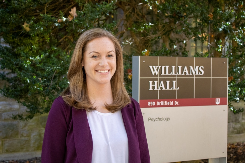 Meagan Brem Meagan Brem stands outside in front of the Williams Hall building sign on Virginia Tech's campus wearing a white shirt and purple blazer jacket.