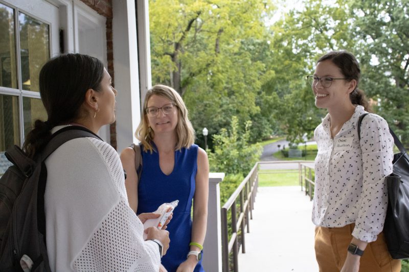 Three new faculty mingle on the porch at the Institute for Society, Culture and Environment at the +Policy Meet and Greet held at the beginning of the 2023 fall semester. 