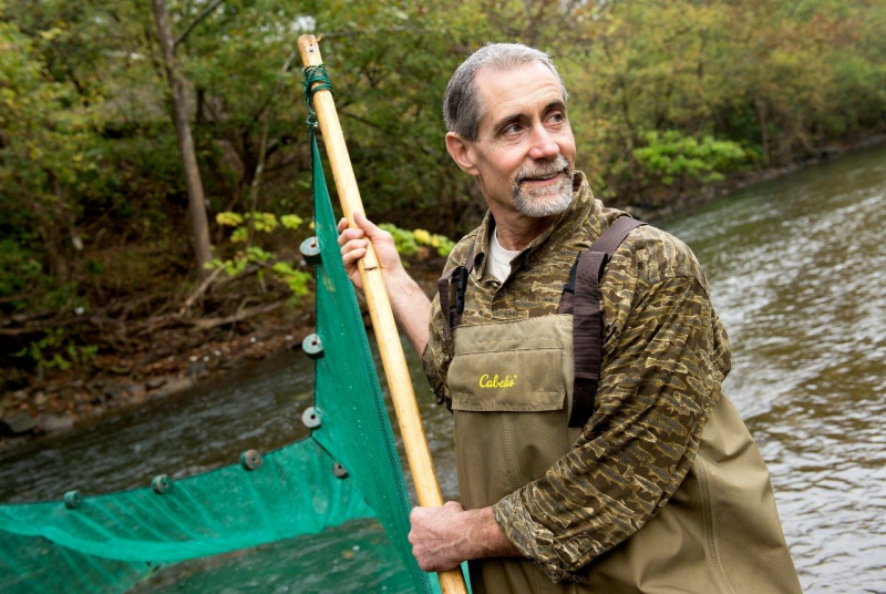 Paul Angermeier, professor of fish conservation in the College of Natural Resources and Environment, engaged in research focused on ecological health of water streams is shown on a river. 